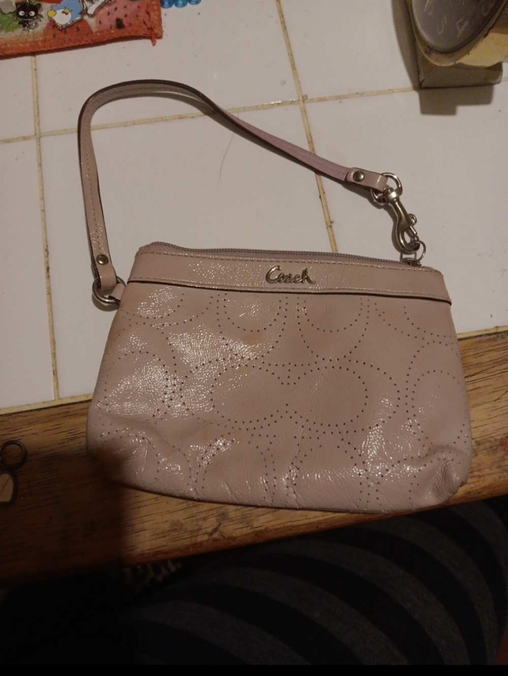mauve-colored Coach Leather Perforated C Wristlet, Small Stain